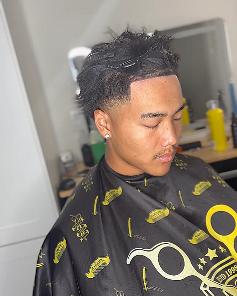 Textured spiky quiff with a blurred mid fade