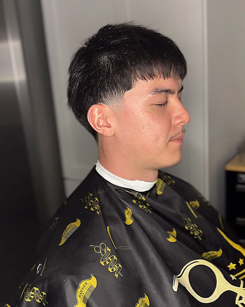 Textured crop with a blunt fringe and low fade