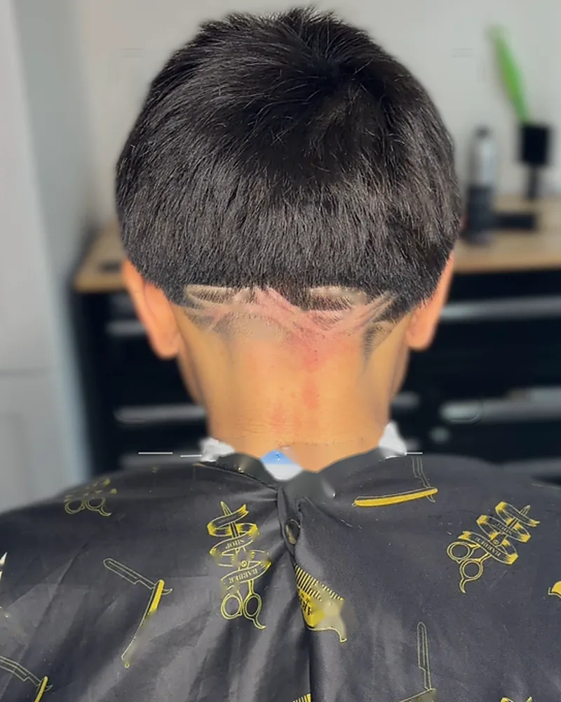 Freehand design shaved into a textured cut, back view