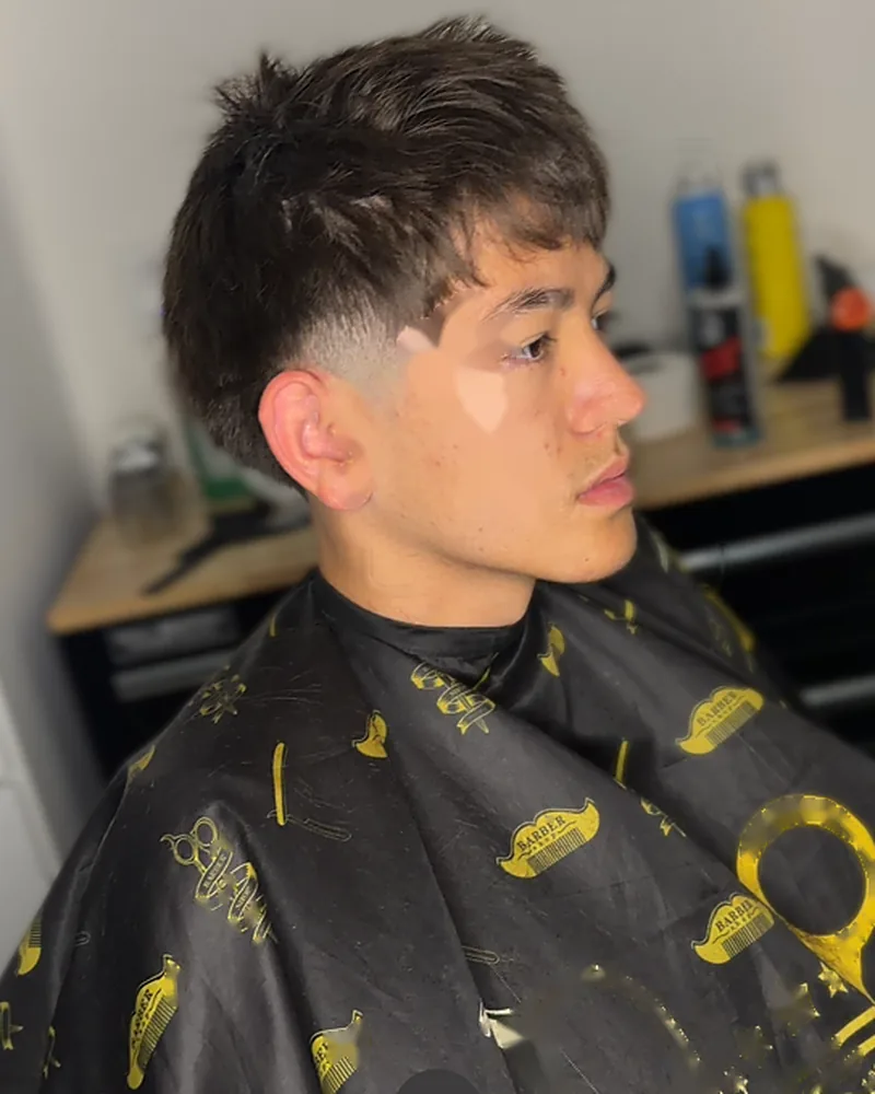 Textured fringe with a skin fade, side profile